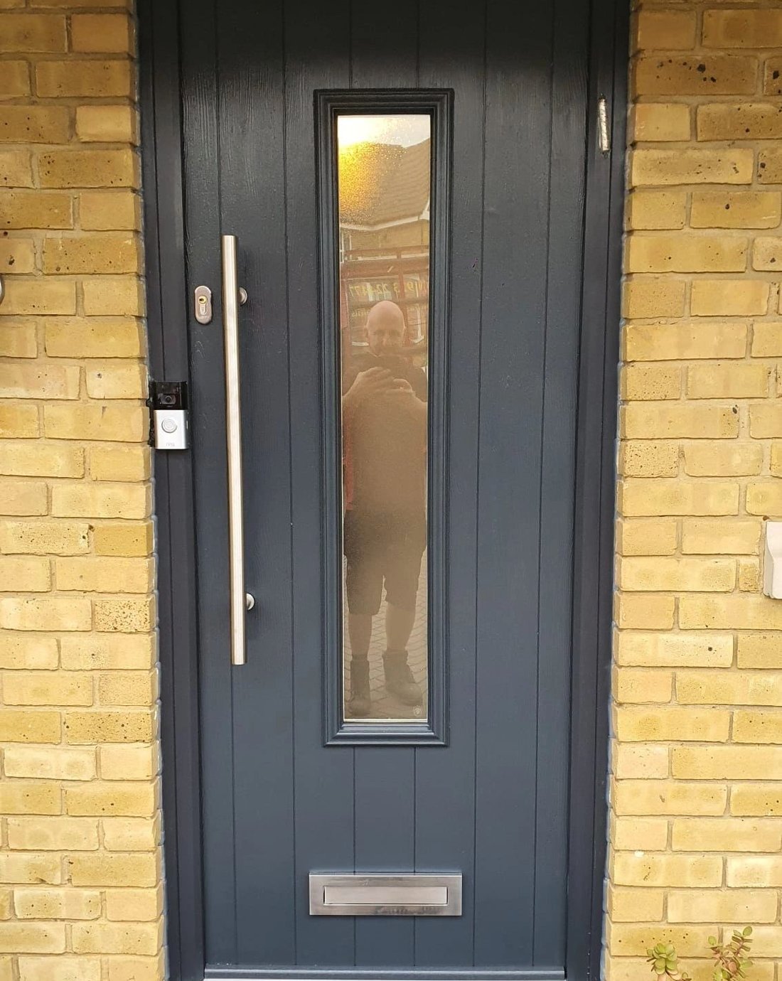 Anthracite composite front door fitted in a brick surround by Precision Fit